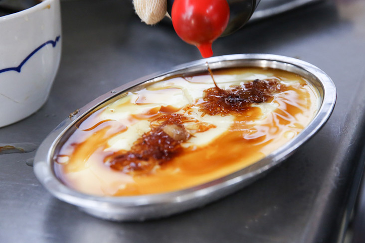 A drizzle of light soy sauce adds flavour to the steamed egg.