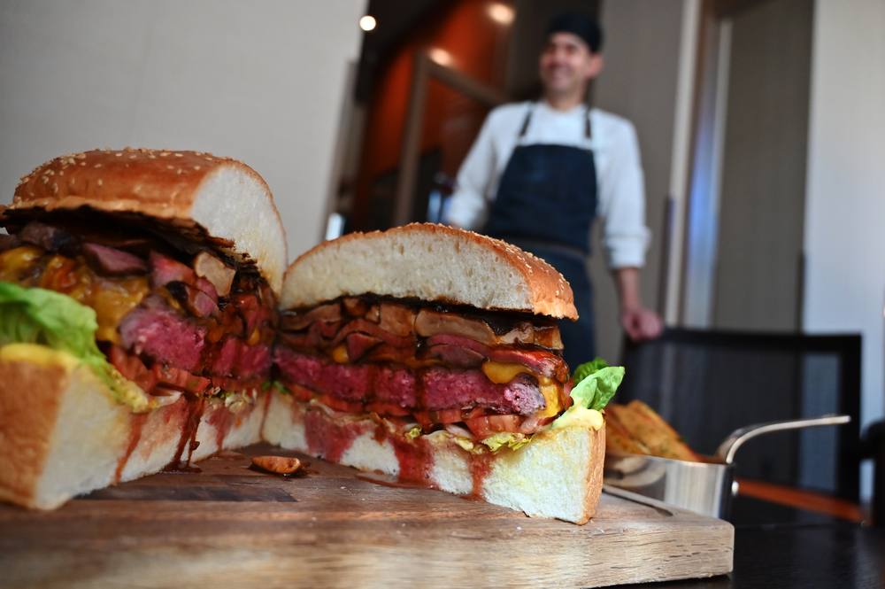 Patrick Shimada, the chef de cuisine at The Oak Door of the Grand Hyatt Tokyo hotel poses with a 3kg burger in Tokyo April 1, 2019. u00e2u20acu201d AFP pic