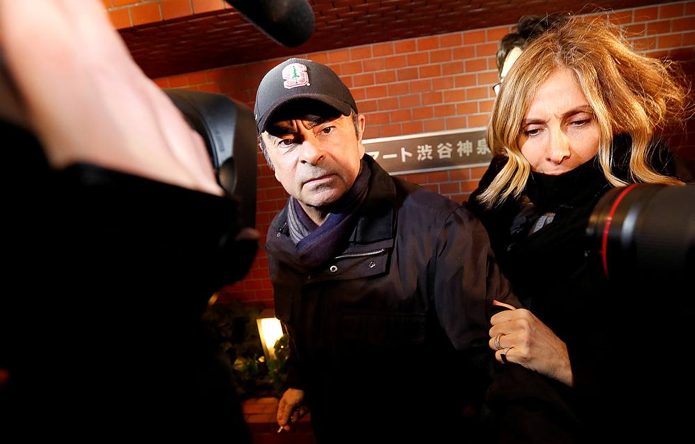 Former Nissan Motor chairman Carlos Ghosn accompanied by his wife Carole Ghosn (right), arrives at his place of residence in Tokyo March 8, 2019. u00e2u20acu201d Reuters pic