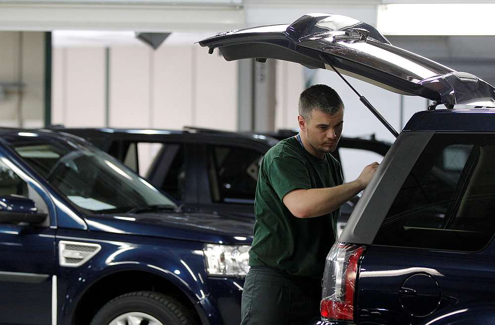 Workers examine Land Rover Freelander vehicles as they come off the production line at Jaguar Land Rover's Halewood assembly plant in Liverpool, northern England, March 2, 2011. u00e2u20acu201d Reuters pic