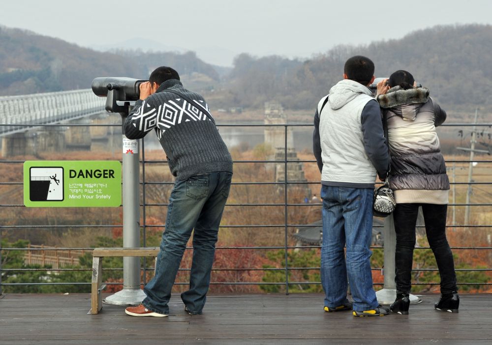 Tourists look at the North through binoculars at Imjingak peace park in Paju. u00e2u20acu201d AFP pic