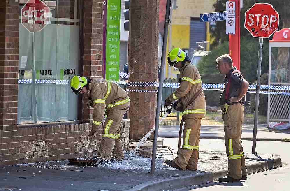 Firemen wash away bloodstains after a security guard was shot dead with another man fighting for his life after a drive-by shooting outside a popular Melbourne nightclub April 14, 2019. The second man is now confirmed dead. u00e2u20acu201d AFP pic