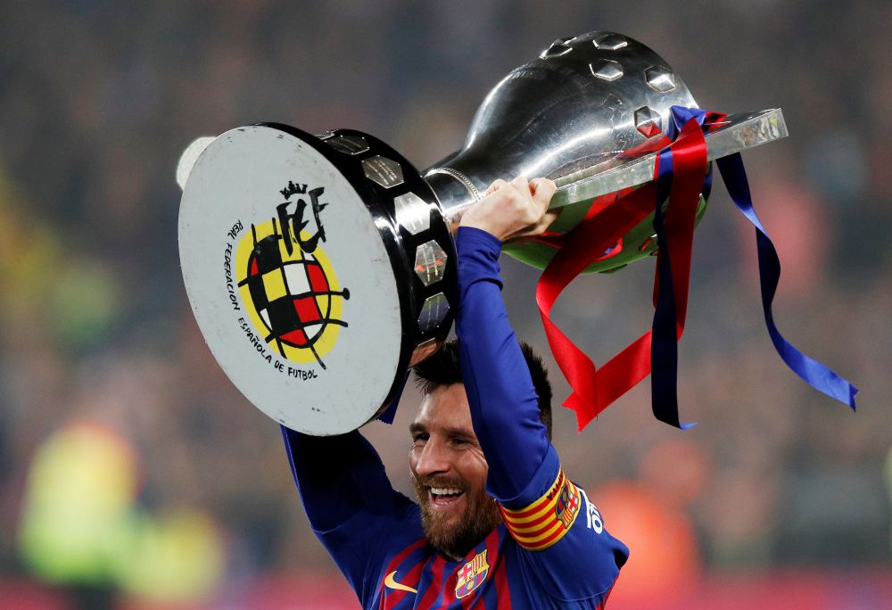 Barcelona's Lionel Messi celebrates winning La Liga with the trophy. u00e2u20acu201d Reuters picnn