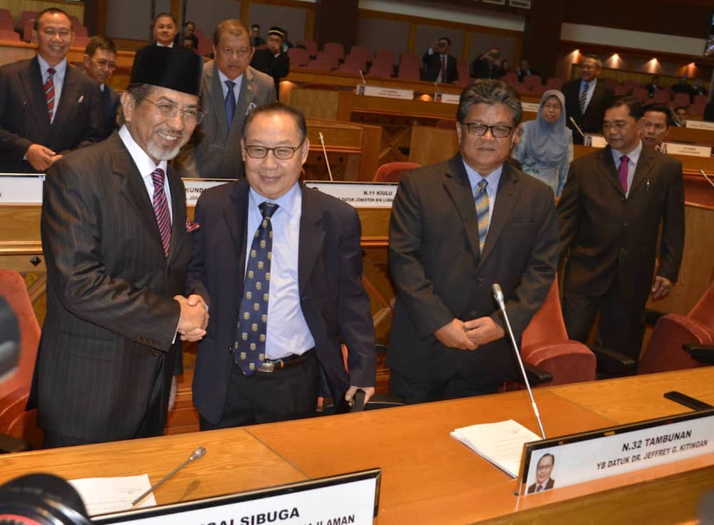 Tan Sri Musa Aman greets other Opposition members in the Sabah state assembly today. u00e2u20acu201d Picture courtesy of Liaw Sin Kuang
