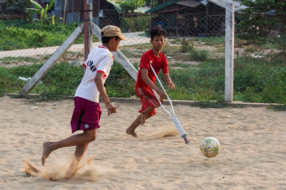 This photo taken on April 2, 2019 shows Kaung Khant Lin (right) playing football with his friends in Yangon. u00e2u20acu2022 AFP pic