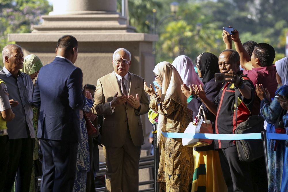 Datuk Seri Najib Razak is pictured praying with his supporters after arriving at the Kuala Lumpur Court Complex April 17, 2019. u00e2u20acu201d Picture by Yusof Mat Isa