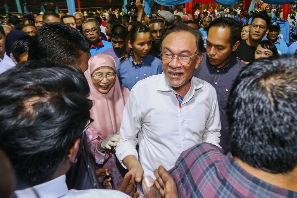 Datuk Seri Anwar Ibrahim is greeted by supporters during PKR's 20th anniversary celebration at Dataran Rantau, Negri Sembilan April 4, 2019. u00e2u20acu201d Picture by Hari Anggara