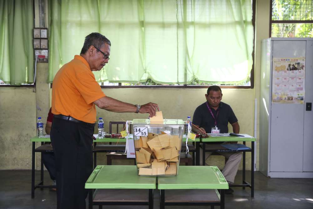 A voter casts his ballot at a polling station in Rantau April 13, 2019. ― Picture by Yusof Mat Isa