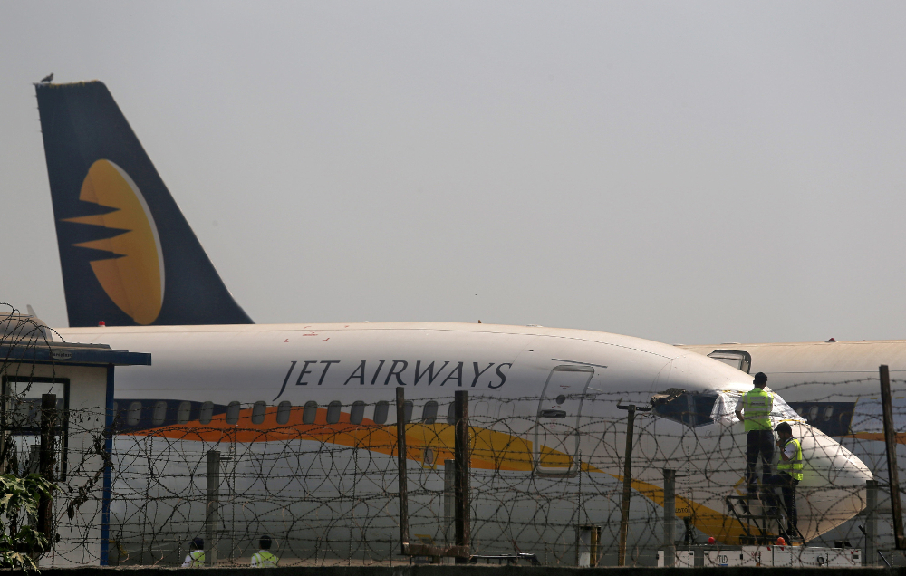 Workers cover the cockpit window of a Jet Airways aircraft parked at the Chhatrapati Shivaji Maharaj International Airport in Mumbai March 26, 2019. u00e2u20acu201d Reuters pic