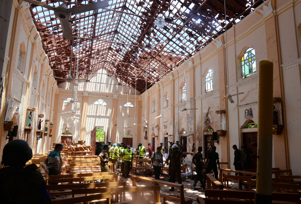 Crime scene officials inspect the site of a bomb blast inside a church in Negombo, Sri Lanka April 21, 2019. u00e2u20acu201d Reuters/Stringer pic