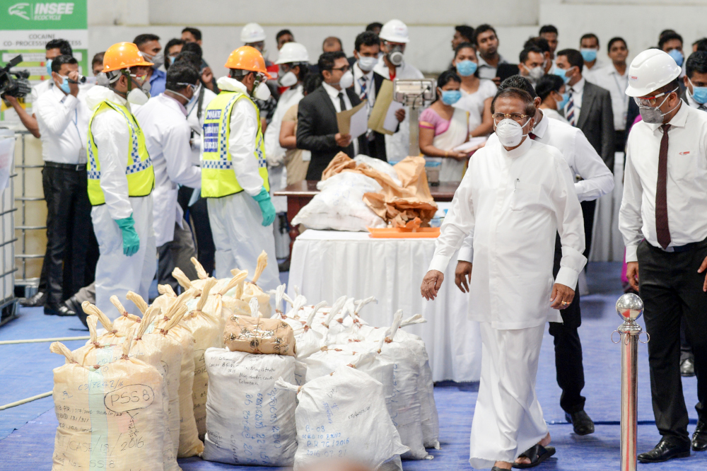 Sri Lankan president Maithripala Sirisena (second right) walks past seized cocaine prepared to be destroyed under judicial supervision at a suburb of Colombo April 1, 2019. u00e2u20acu201d AFP pic 