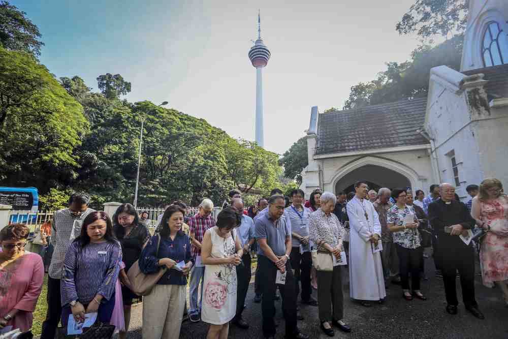 Congregants of the St Andrew’s Presbyterian Church along Jalan Raja Chulan pray during the unveiling ceremony of the bell tower, April 7, 2019.