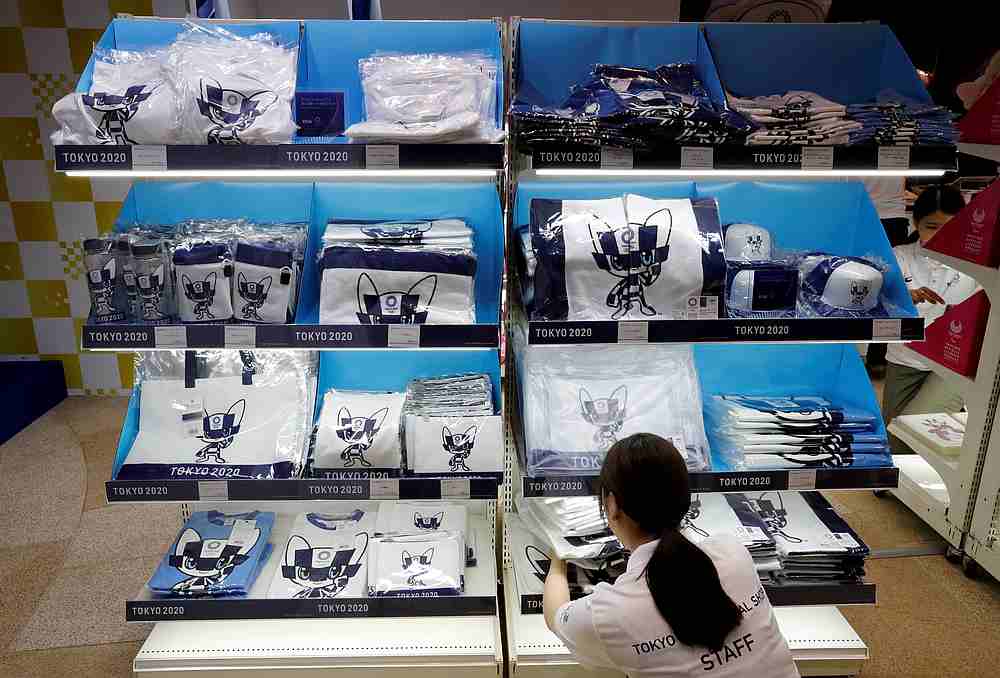 A staff member arranges products at the Tokyo 2020 Olympic Games mascot house in Tokyo July 22, 2018. — Reuters pic