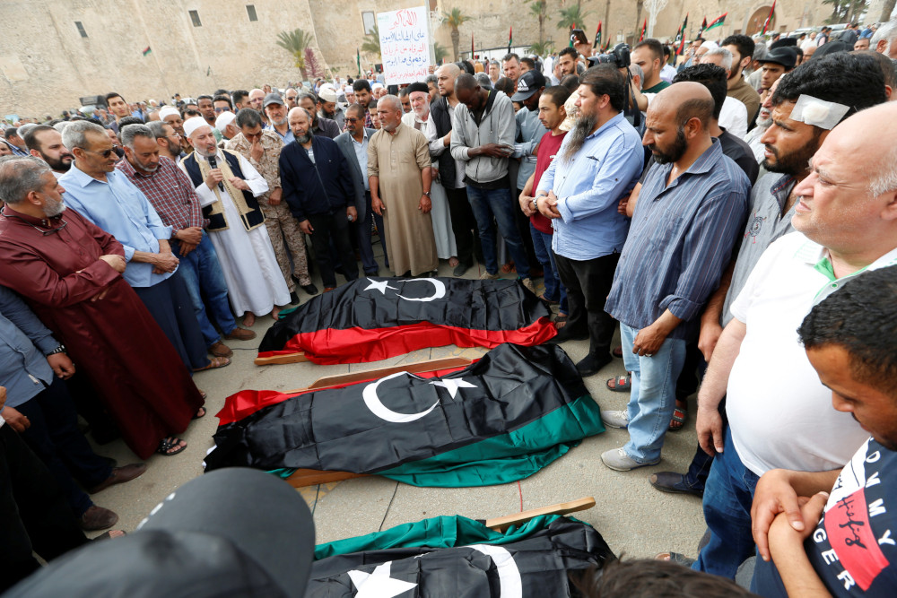 People pray near coffins draped with Libyan flags, with the bodies of members of the Libyan internationally recognised government forces who were killed during clashes, during a funeral in Tripoli, Libya April 24, 2019. u00e2u20acu201d Reuters pic
