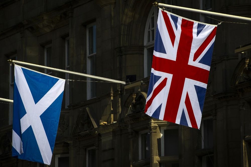 Flags of Scotland (left) and the Union hang from flagpoles in Edinburgh, Scotland on April 11, 2019. With Britain tearing its hair out over the Brexit confusion, Scotlandu00e2u20acu2122s government is biding its time as it prepares for independence. u00e2u20acu201d AFP pic
