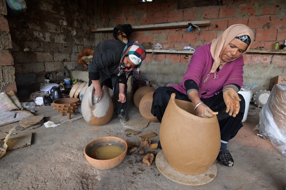 Sabiha Ayari (left), a Tunisian potter in her fifties, works with her sister-in-law in the village of Sejnane in the northern Tunisian province of Bizerte March 14, 2019. — AFP pic