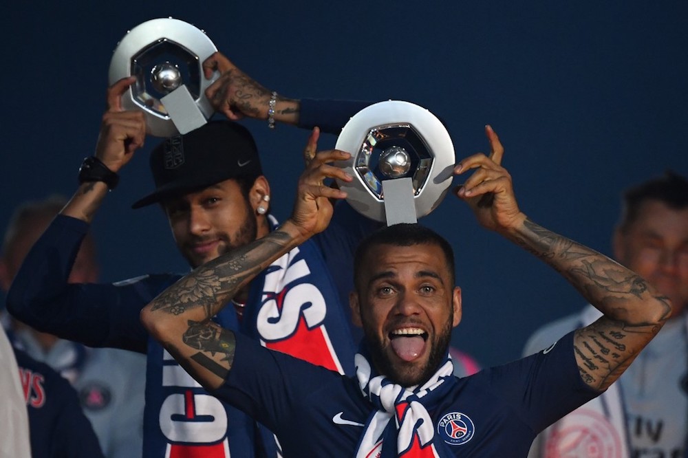 Paris Saint-Germainu00e2u20acu2122s Neymar and Dani Alves celebrate with their Championu00e2u20acu2122s trophy at the end of the French L1 match with Dijon at the Parc des Princes stadium in Paris May 18, 2019. u00e2u20acu201d AFP pic