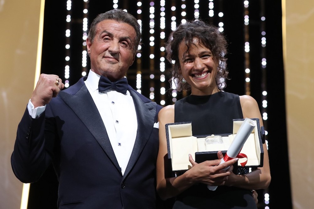 Director Mati Diop poses on stage with Sylvester Stallone after winning the Grand Prix for her film u00e2u20acu02dcAtlanticsu00e2u20acu2122 at the 72nd edition of the Cannes Film Festival May 25, 2019. u00e2u20acu201d AFP pic