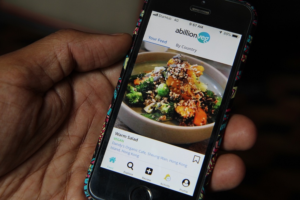 Vikas Garg, founder of abillionveg, shows a mobile phone app that reviews vegetarian and vegan dishes, demonstrating how to use it in Singapore February 12, 2019. u00e2u20acu201d Thomson Reuters Foundation/Thin Lei Win pic