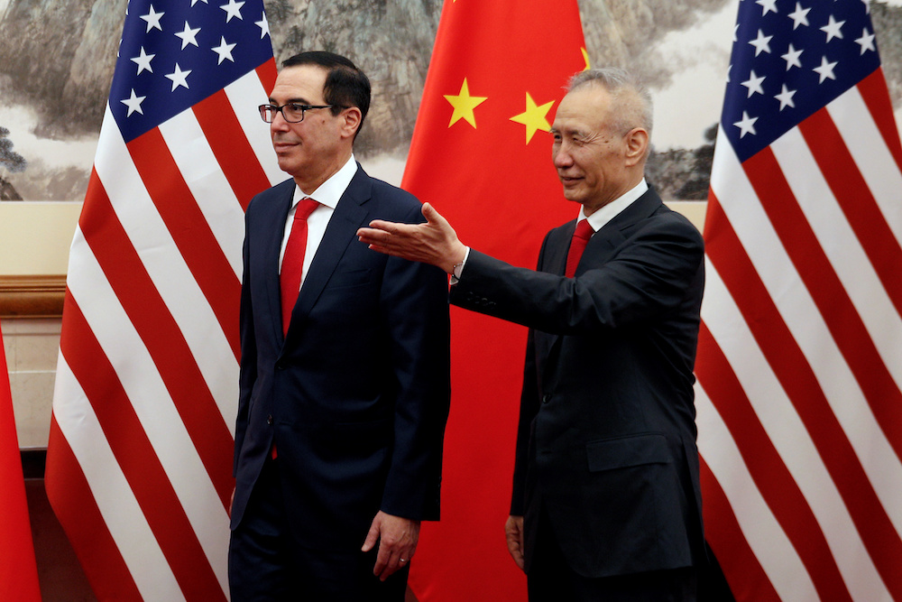 Chinese Vice Premier Liu He, right, shows the way to US Treasury Secretary Steven Mnuchin as they proceed to their meeting at the Diaoyutai State Guesthouse in Beijing May 1, 2019. u00e2u20acu201d Andy Wong/Pool handout via Reuters