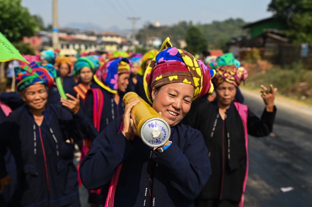 In this picture taken on April 29, 2019, Pa'O ethnic women dance as they bring a homemade rocket to launch during a festival in Nantar, Shan state. u00e2u20acu201d AFP pic