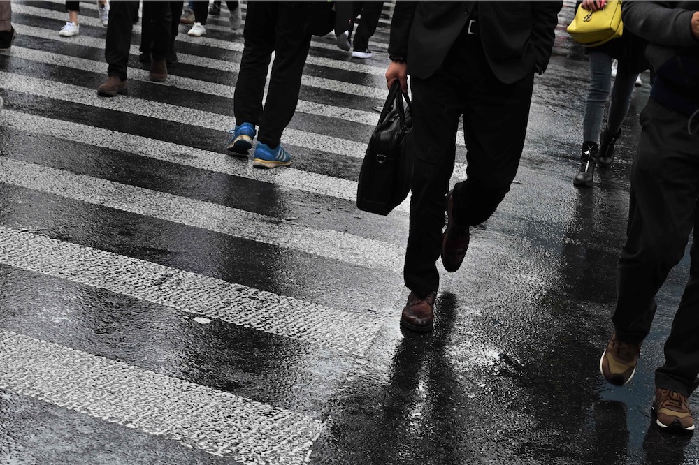 People walk to work in Shanghai April 30, 2019. u00e2u20acu201d AFP pic