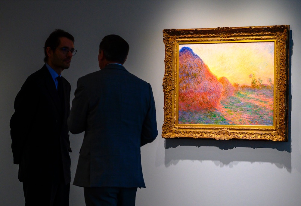 In this file photo taken on May 2, 2019 Sotheby's officials stand near one of Claude Monet's Meules during a media preview in New York. u00e2u20acu201d AFP pic