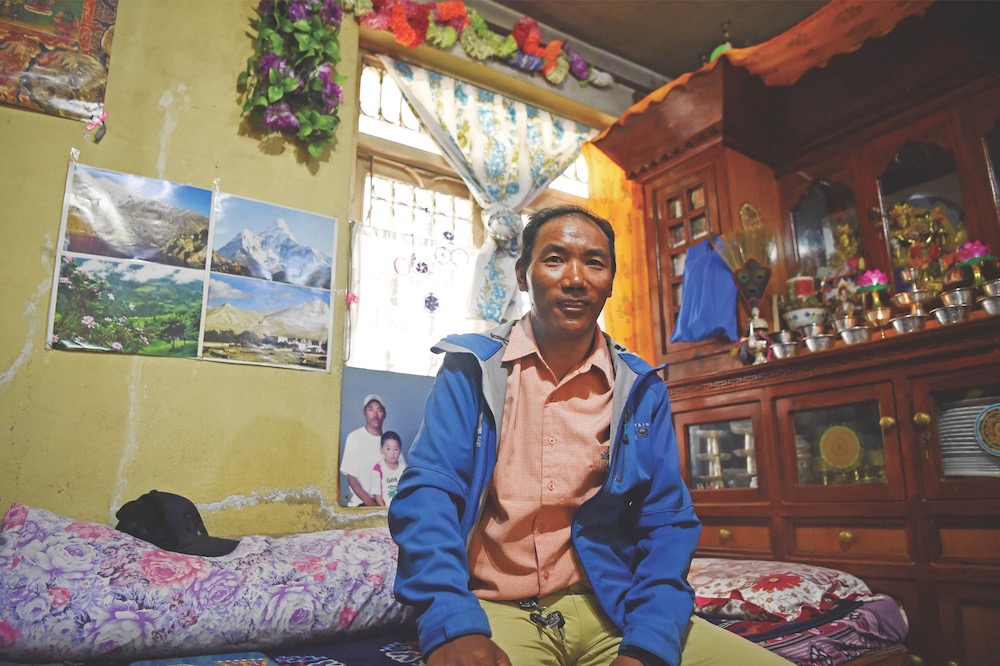 This photograph taken on March 28, 2018 shows Nepali mountaineer Kami Rita Sherpa sitting in his rented room at Boudhanath Stupa, on the outskirts of Kathmandu.— AFP pic