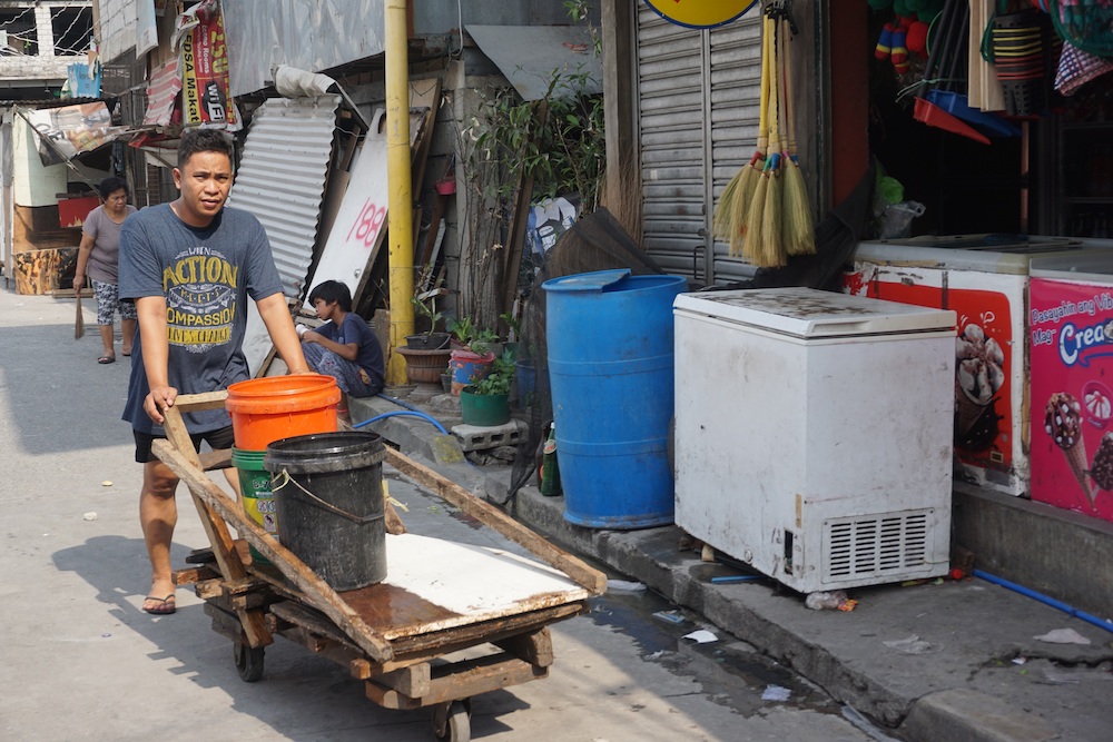 A man carts water to his home after filling up buckets at a neighbour's house on lower ground during water shortages in Addition Hills, a slum in Metro Manila April 8, 2019. u00e2u20acu201d Thomson Reuters Foundation/Matt Blomberg pic