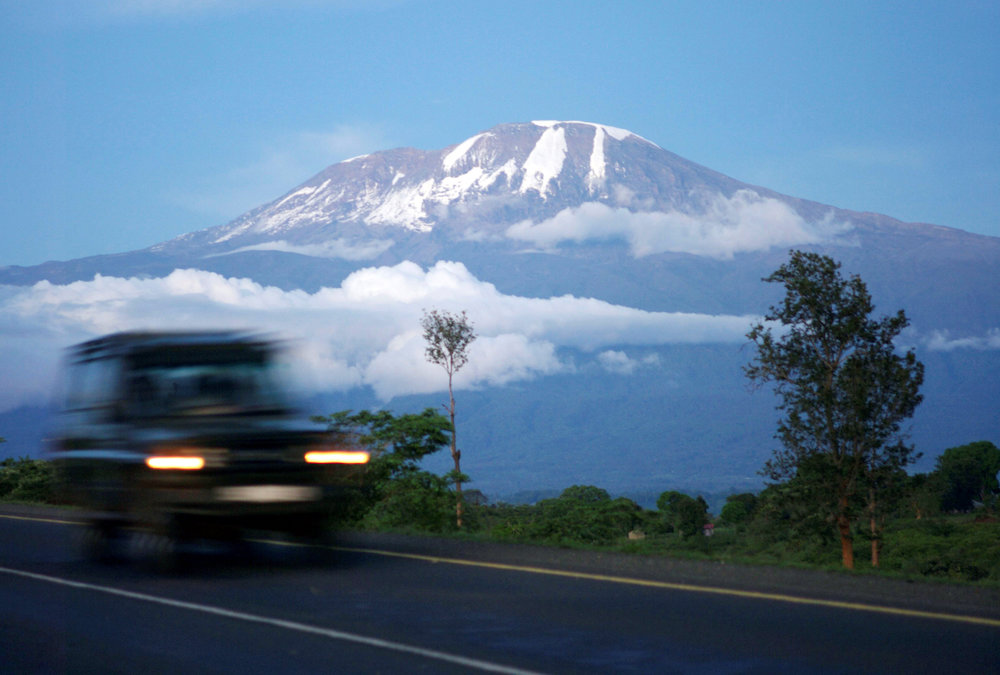 A vehicle drives past Mount Kilimanjaro in Tanzaniau00e2u20acu2122s Hie district December 10, 2009. u00e2u20acu201d Reuters pic