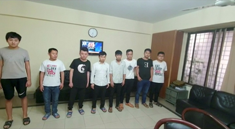 Chinese nationals who are suspected members of a prostitution ring taking young Pakistani women to China, stand in line after their detention, in Lahore May 9, 2019. u00e2u20acu201d Screeeen capture via Reuters TV