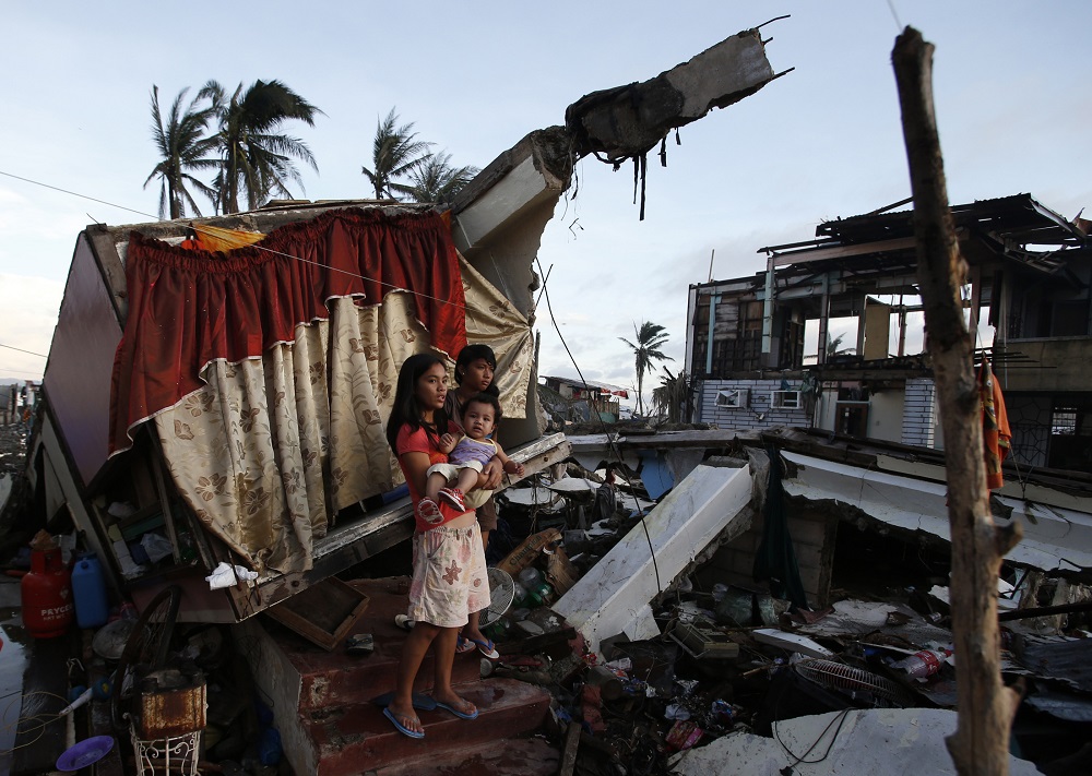 Typhoon Haiyan survivors stand at the entrance of a toppled house that has become a makeshift shelter in Tacloban city in central Philippines December 15, 2013. u00e2u20acu201d Reuters pic