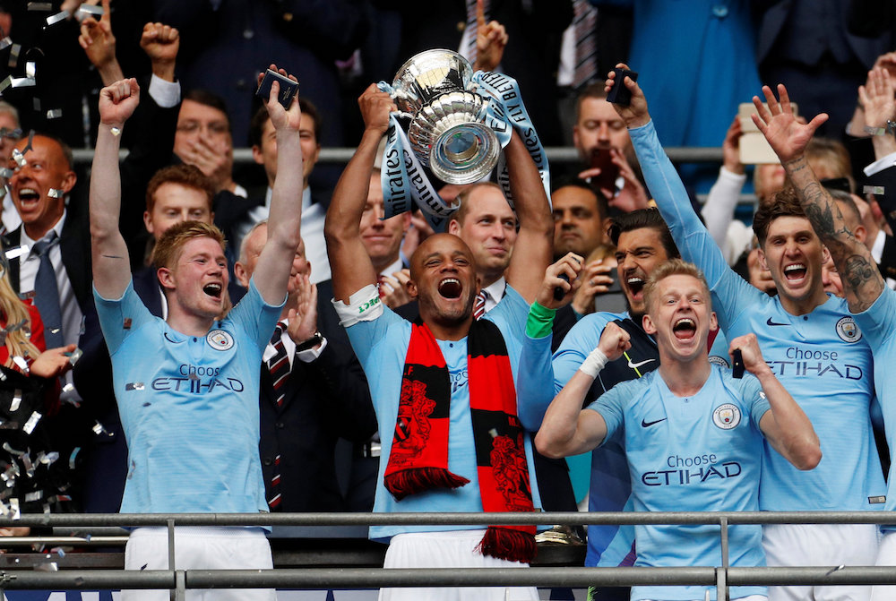 Manchester Cityu00e2u20acu2122s Vincent Kompany lifts the trophy as they celebrate after winning the FA Cup at Wembley Stadium in London May 18, 2019. u00e2u20acu201d Action Images pic via Reuters