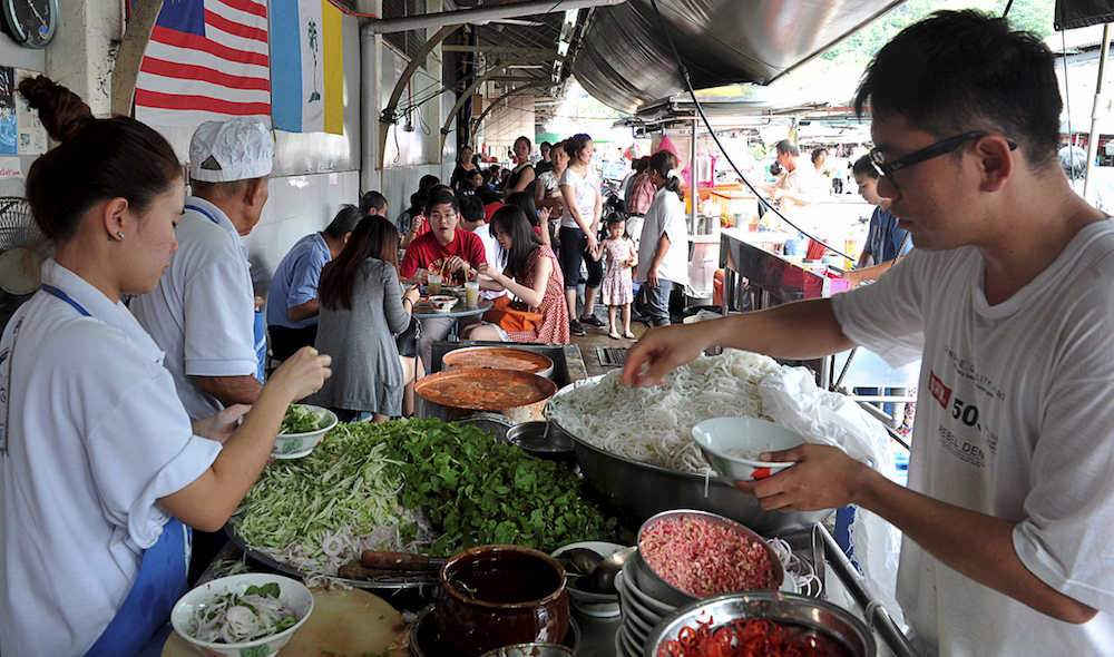 People eat assam laksa in George Town May 2, 2019. u00e2u20acu201d Picture by Sayuti Zainudin