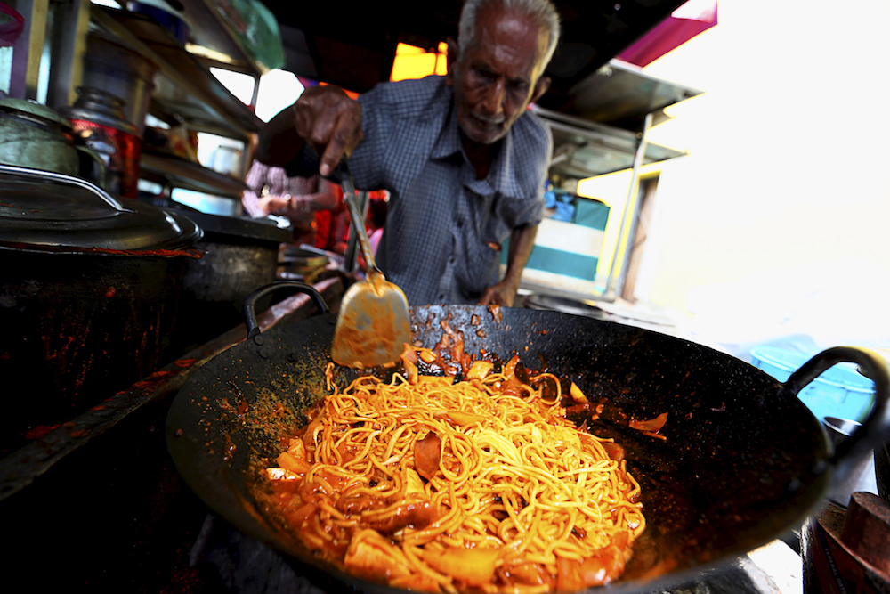 A man fries noodles in George Town May 2, 2019. u00e2u20acu201d Picture by Sayuti Zainudin