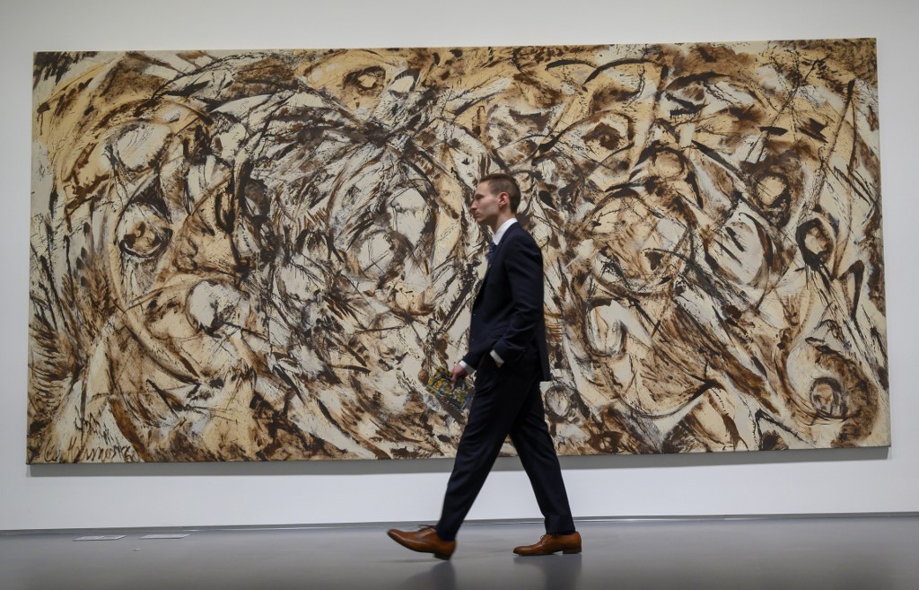 A man walks past Lee Krasneru00e2u20acu2122s u00e2u20acu02dcThe Eye is the First Circleu00e2u20acu2122 during a media preview, for Sothebyu00e2u20acu2122s Impressionist & Modern Art and Contemporary Art auctions, May 3, 2019 in New York.  u00e2u20acu201d AFP picnn