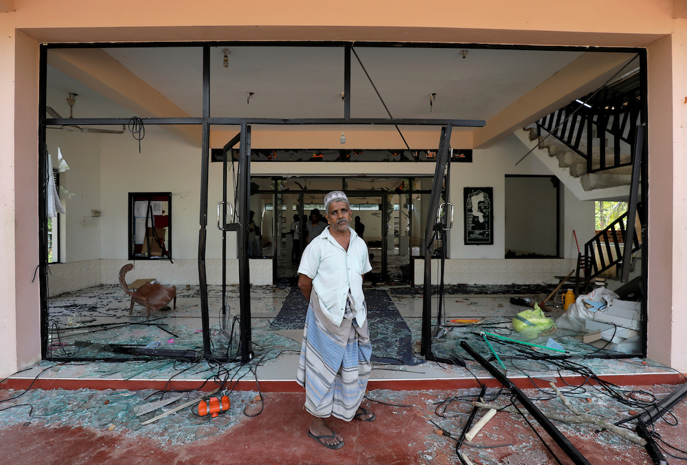 A Muslim man stands in front of the Abbraar Masjid mosque after a mob attack in Kiniyama, Sri Lanka May 13, 2019. u00e2u20acu201d Reuters pic
