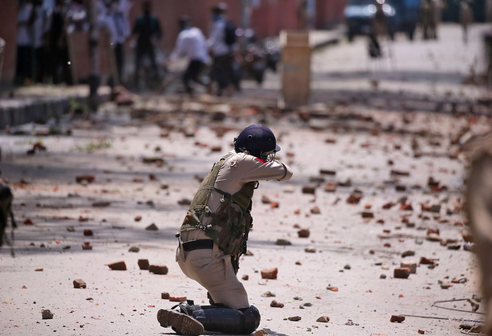 An Indian policeman fires a tear smoke shell towards students during a protest against the rape of a three-year-old girl in north Kashmir's Bandipora district last week, in Srinagar May 14, 2019. u00e2u20acu201d Reuters picnn