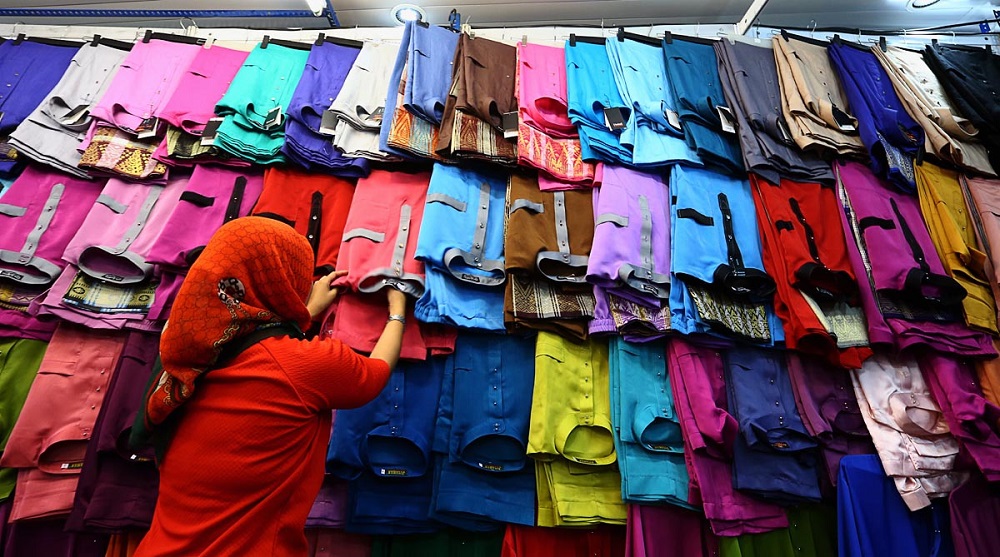 A storekeeper arranges traditional Malay attire at one of the stalls in Komtar ahead of the Hari Raya celebration in George Town May 15, 2019. u00e2u20acu201d Picture by Sayuti Zainudin