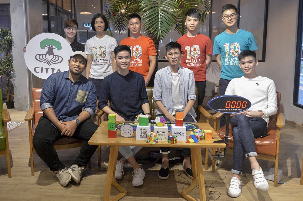The Siew family, Muhammad Hariz Azizan, Malaysia Cube Association president Leow Yi Jun, treasurer Junwen Wang and Citta Mall advertising and promotions assistant manager Alisson Chan poses for a photo during a press conference yesterday at Union Roastery in Citta Mall. 
