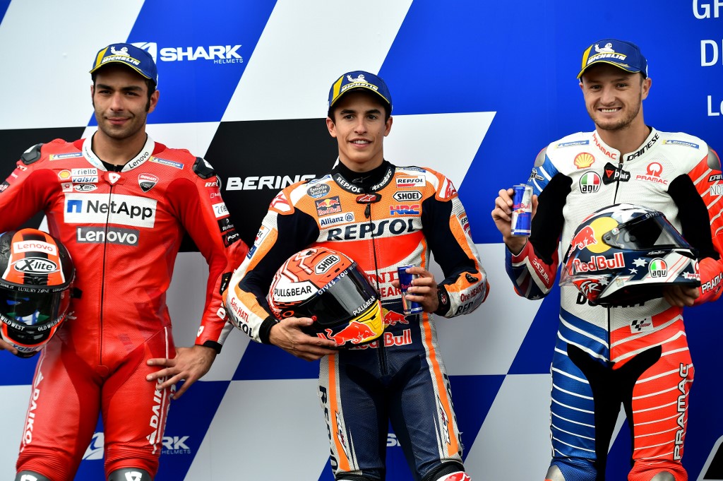 Marc Marquez (centre) poses with Ducatiu00e2u20acu2122s Danilo Petrucci (left) and Jack Miller after the MotoGP qualifying practice session, ahead of the French Motorcycle Grand Prix, on May 18, 2019,in Le Mans, northwestern France. u00e2u20acu201d AFP picnn