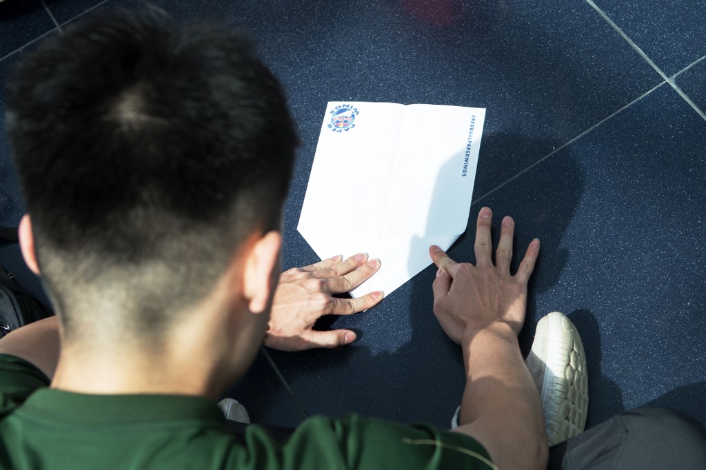 A participant in the Red Bull Paper Wings World Finals 2019 folds a paper plane in Salzburg May 17, 2019. u00e2u20acu201d AFP picnn