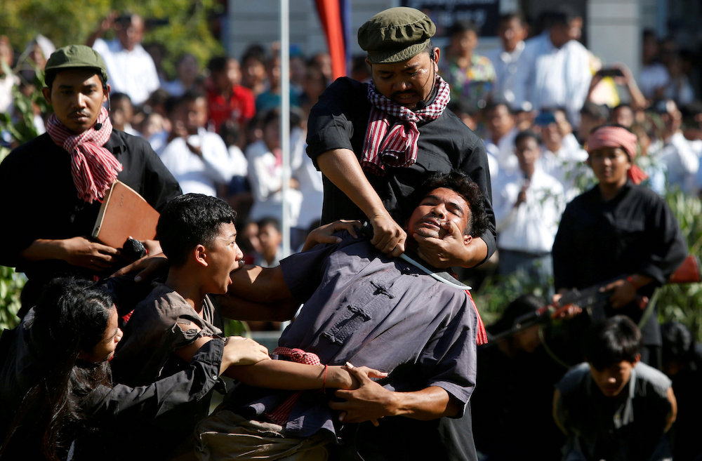 Actors reenact a scene based on the Khmer Rouge regime tactics during the annual u00e2u20acu02dcDay of Angeru00e2u20acu2122 where people gather to remember those who perished during the Communist regimeu00e2u20acu2122s rule, on the outskirts of Phnom Penh May 20, 2019. u00e2u20acu201d Reuters picnn