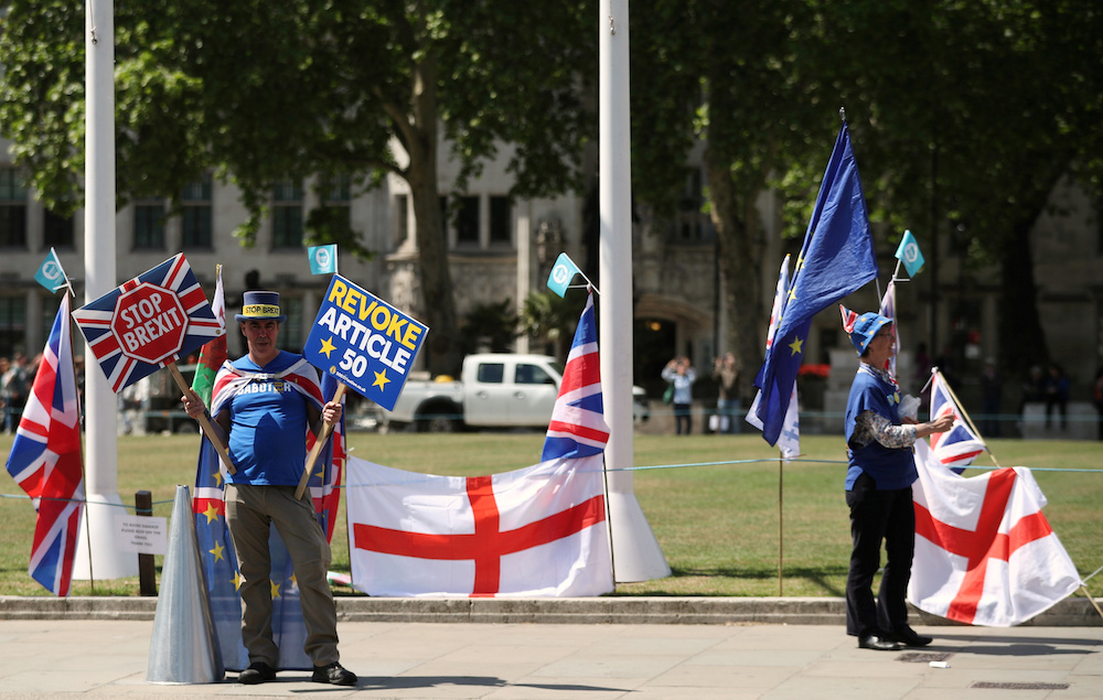 Anti-Brexit protesters are seen outside the Houses of Parliament in London May 21, 2019. u00e2u20acu201d Reuters picnn