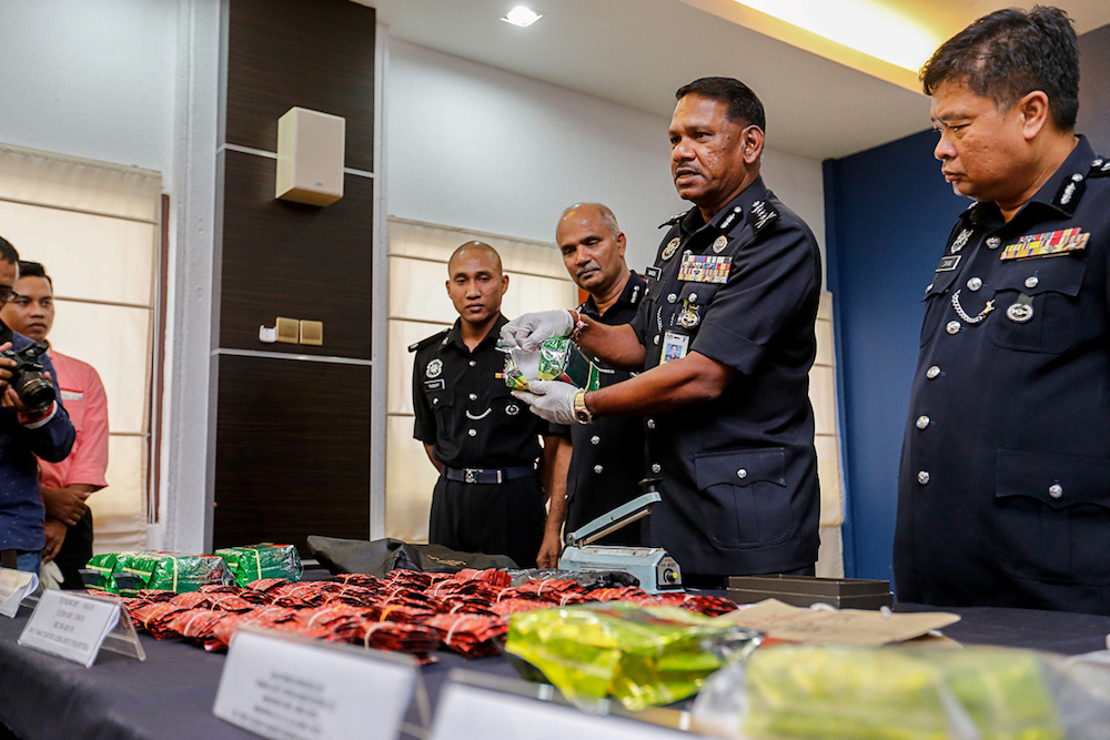 Penang CPO Datuk T. Narenasagaran (middle) shows some of the drugs seized during a press conference at the Penang Police Contingent in George Town May 23, 2019. u00e2u20acu201d Picture by Sayuti Zainudin