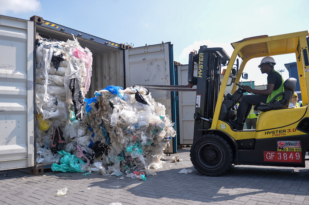 A forklift pulls out imported plastic waste from a container in Port Klang May 28, 2019. — Picture by Mukhriz Hazim