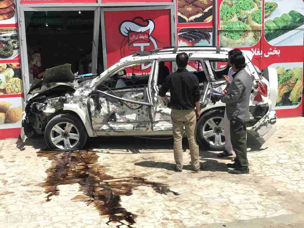 Afghans look at at a car hit damaged a suicide bomb blast in Kabul May 31, 2019. u00e2u20acu2022 Reuters pic