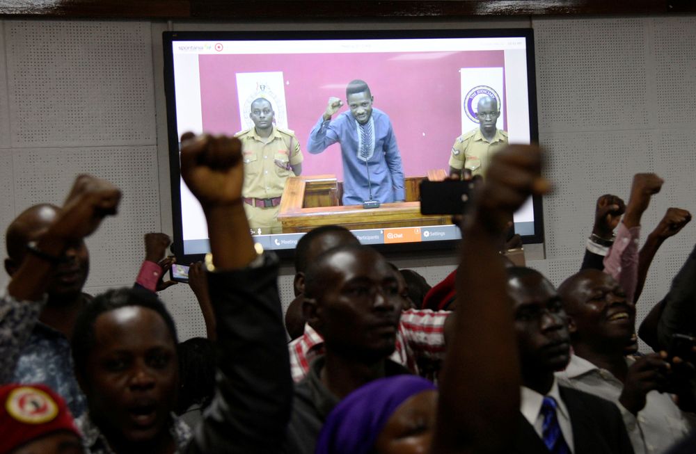 Supporters cheer as Ugandan lawmaker Robert Kyagulanyi, also known as Bobi Wine, is seen on a television screen showing him during a live stream from Luzira prison, at the Buganda Road Court, in Kampala, Uganda, May 2, 2019. u00e2u20acu201d Reuters pic