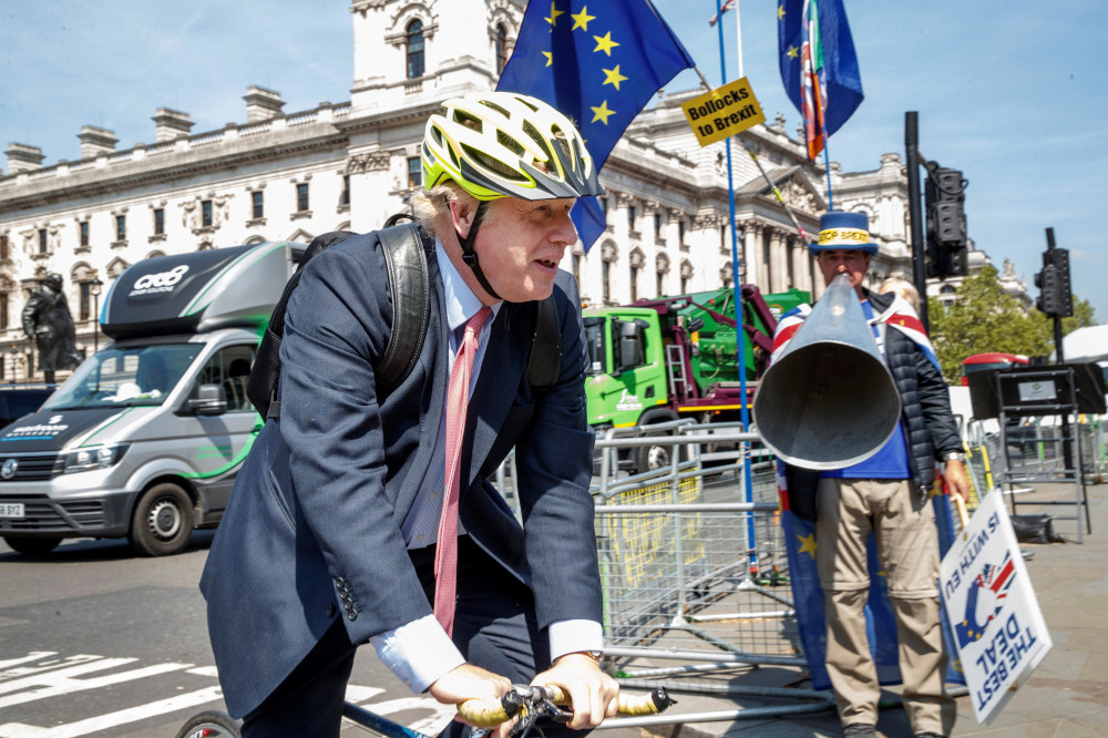 Pro-Brexit Conservative MP Boris Johnson rides his bicycle as he arrives at the Houses of Parliament in London May 15, 2019. u00e2u20acu201d AFP pic 