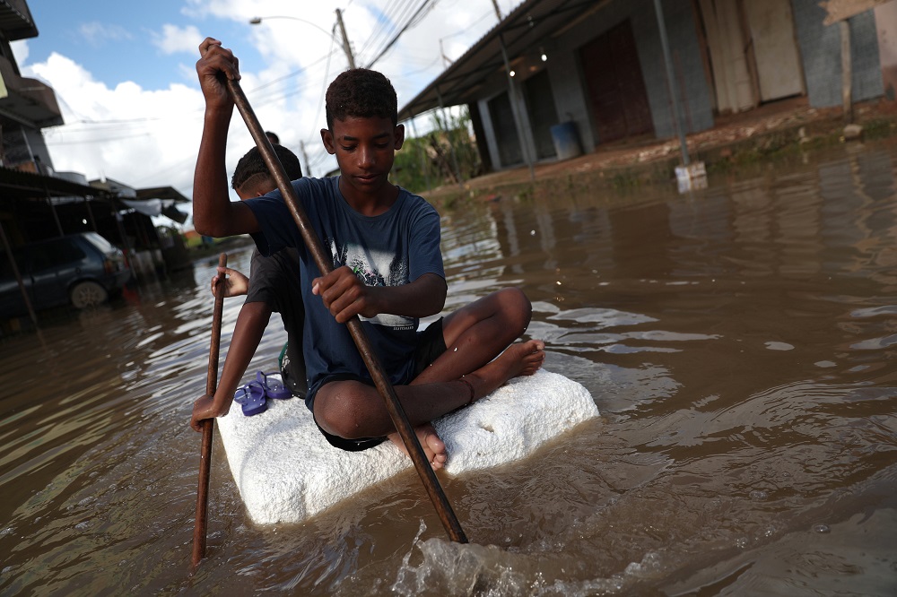 Kids are pictured at a flooded street during heavy rains in the Guaratiba neighbourhood in Rio de Janeiro, Brazil April 10, 2019. u00e2u20acu2022 Reuters pic